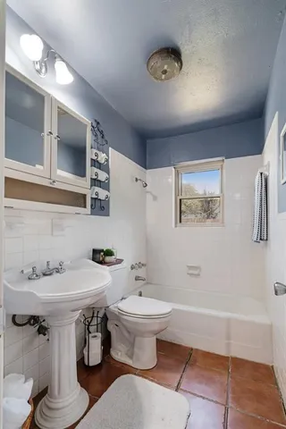 a bathroom with a sink toilet and mirror