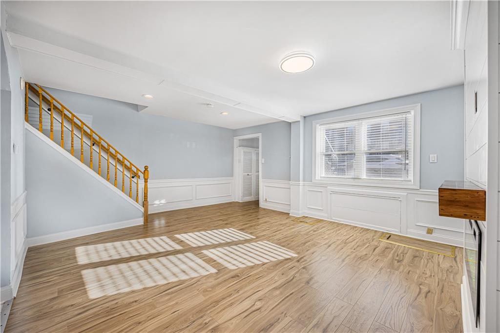 1859 Stuart Street Brooklyn, NY 11229 - Photo 4 of 4 a view of an empty room with wooden floor and a window