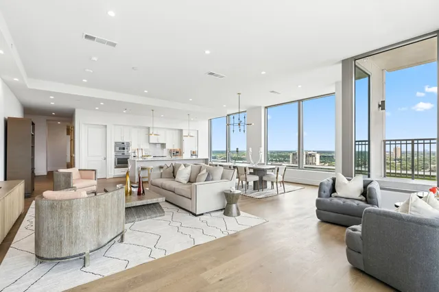 a view of a dining room with furniture large windows and wooden floor