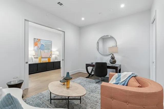 a living room with furniture and a chair