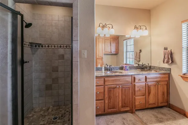 a bathroom with a double vanity sink and a mirror