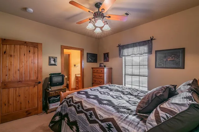 a bedroom that has a bed and a chandelier