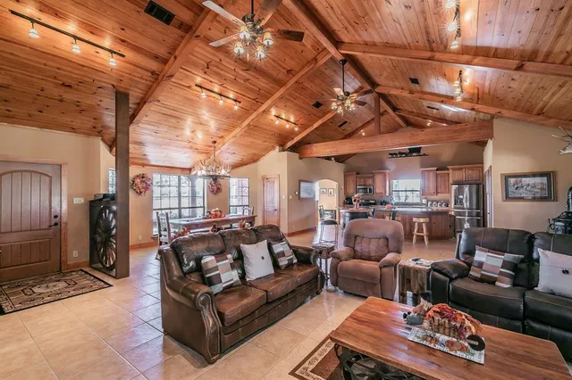 a living room with furniture a couch and a chandelier