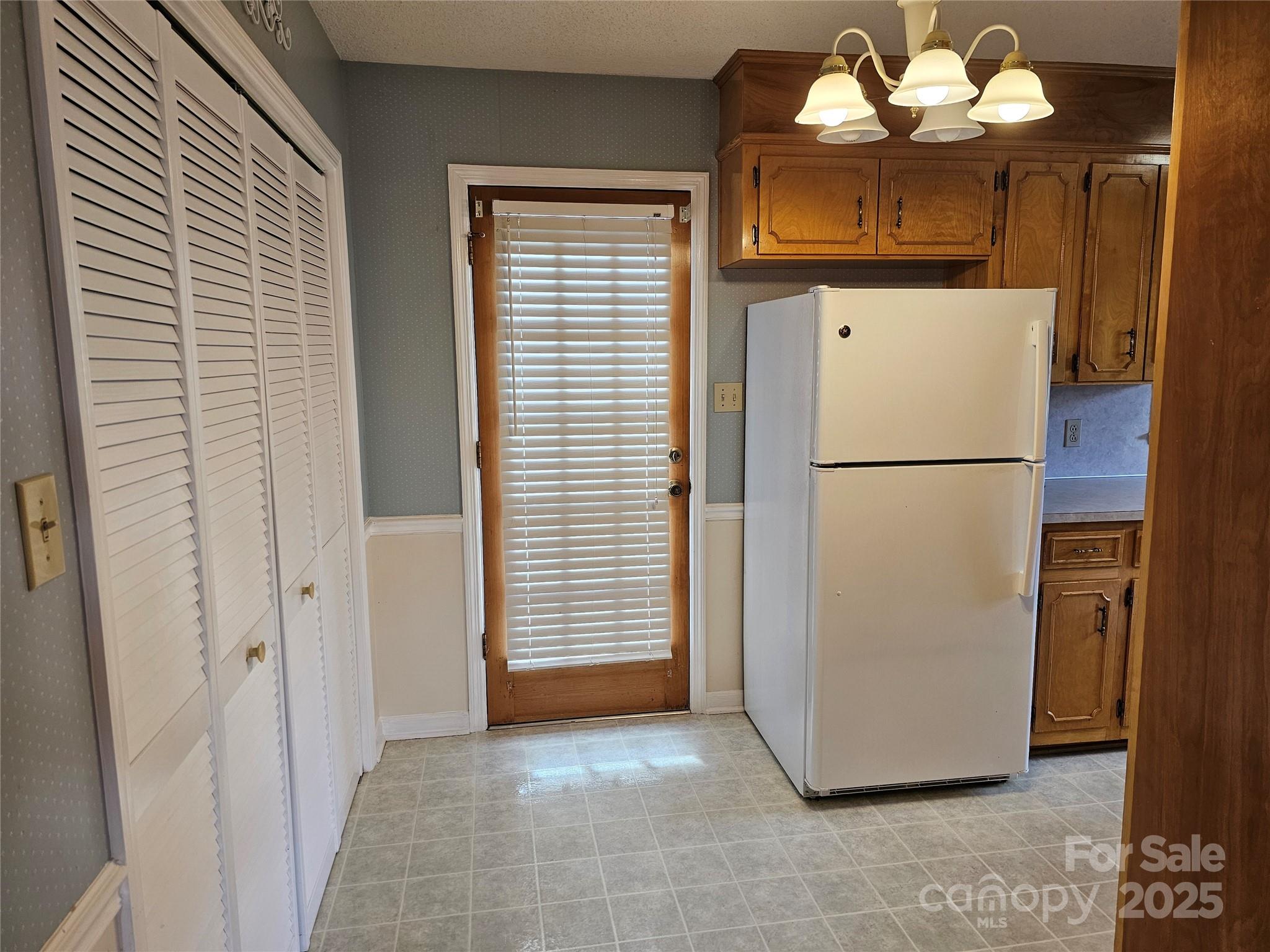2486 Oxford Circle Lancaster, SC 29720 - Photo 5 of 17 a view of a refrigerator in kitchen and an empty room