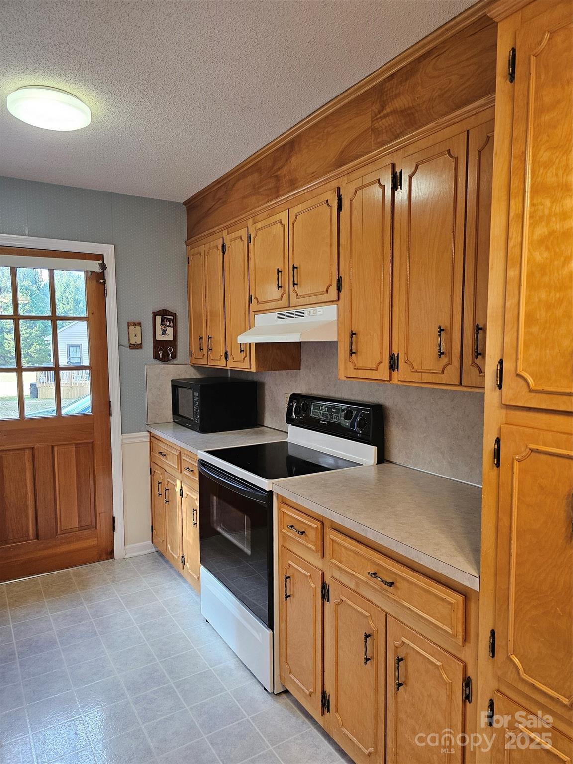 2486 Oxford Circle Lancaster, SC 29720 - Photo 7 of 17 a kitchen with stainless steel appliances granite countertop a stove a sink and a refrigerator