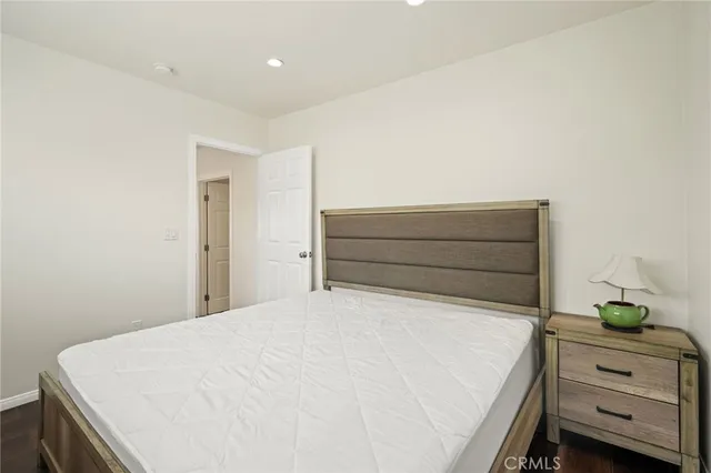 a bedroom with a bed and a dresser