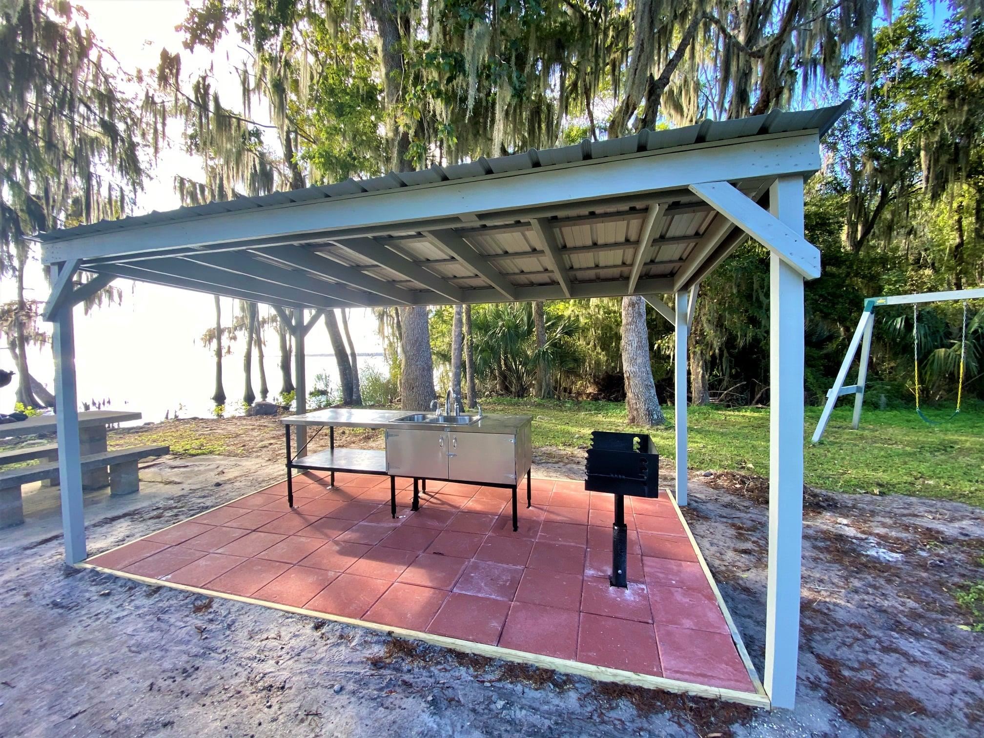 243-245 Georgetown Denver Road Georgetown, FL 32139 - Photo 2 of 9 a view of a patio with a table chairs and a backyard