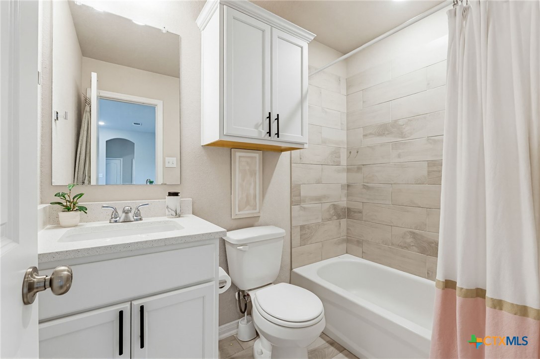 1761 Spence Street Temple, TX 76502 - Photo 17 of 30 a bathroom with a sink a toilet and shower