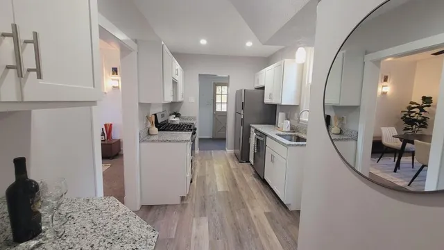 a kitchen with stainless steel appliances granite countertop a refrigerator and a stove