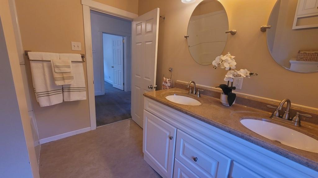 2907 Main Street Homestead, PA 15120 - Photo 9 of 14 a bathroom with a double vanity sink and a mirror