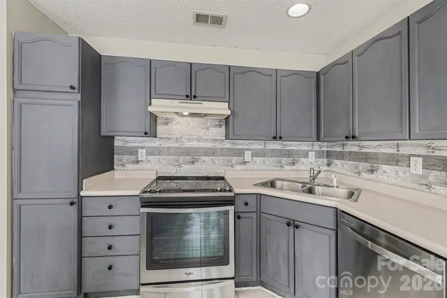 a kitchen with cabinets appliances and a sink