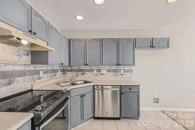 a kitchen with a sink stove and cabinets