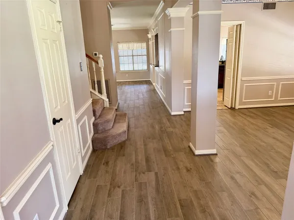 wooden floor in an empty room with a window