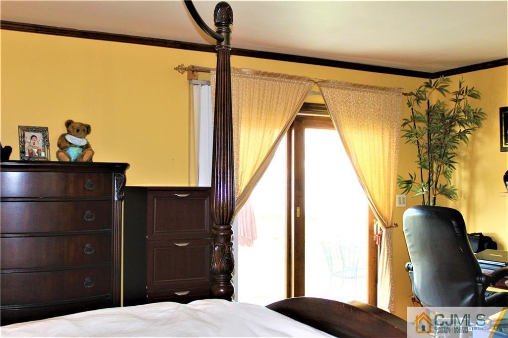 1 Windsor Road Edison, NJ 08817 - Photo 22 of 37 a bedroom with a bed and a painting on the wall