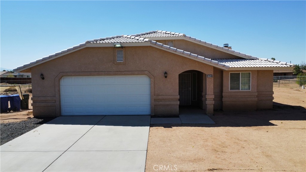 12848 Pawnee Road Apple Valley, CA 92308 - Photo 1 of 1 a front view of a house