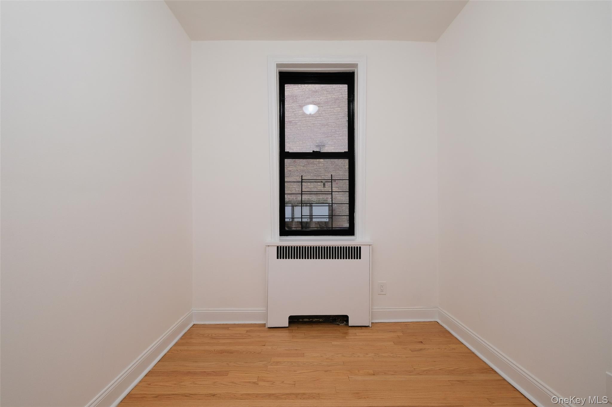 340 East Mosholu Parkway South, Unit 1A Bronx, NY 10458 - Photo 5 of 10 a view of a small space with wooden floor and a window