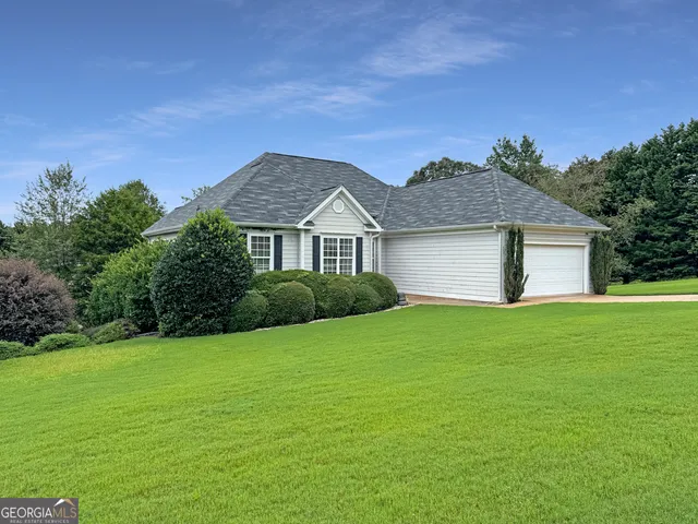 a front view of a house with a garden
