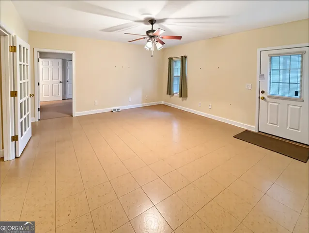 a view of an empty room with a window