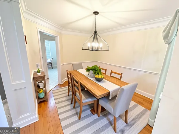 a view of a dining room with furniture wooden floor and chandelier