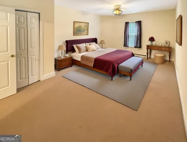 a living room with a bed furniture and a window