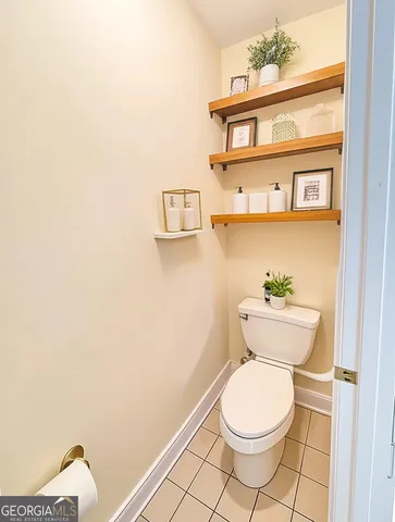 a white toilet sitting next to a bathroom sink
