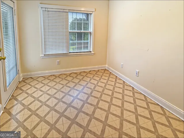 a view of an empty room and a window