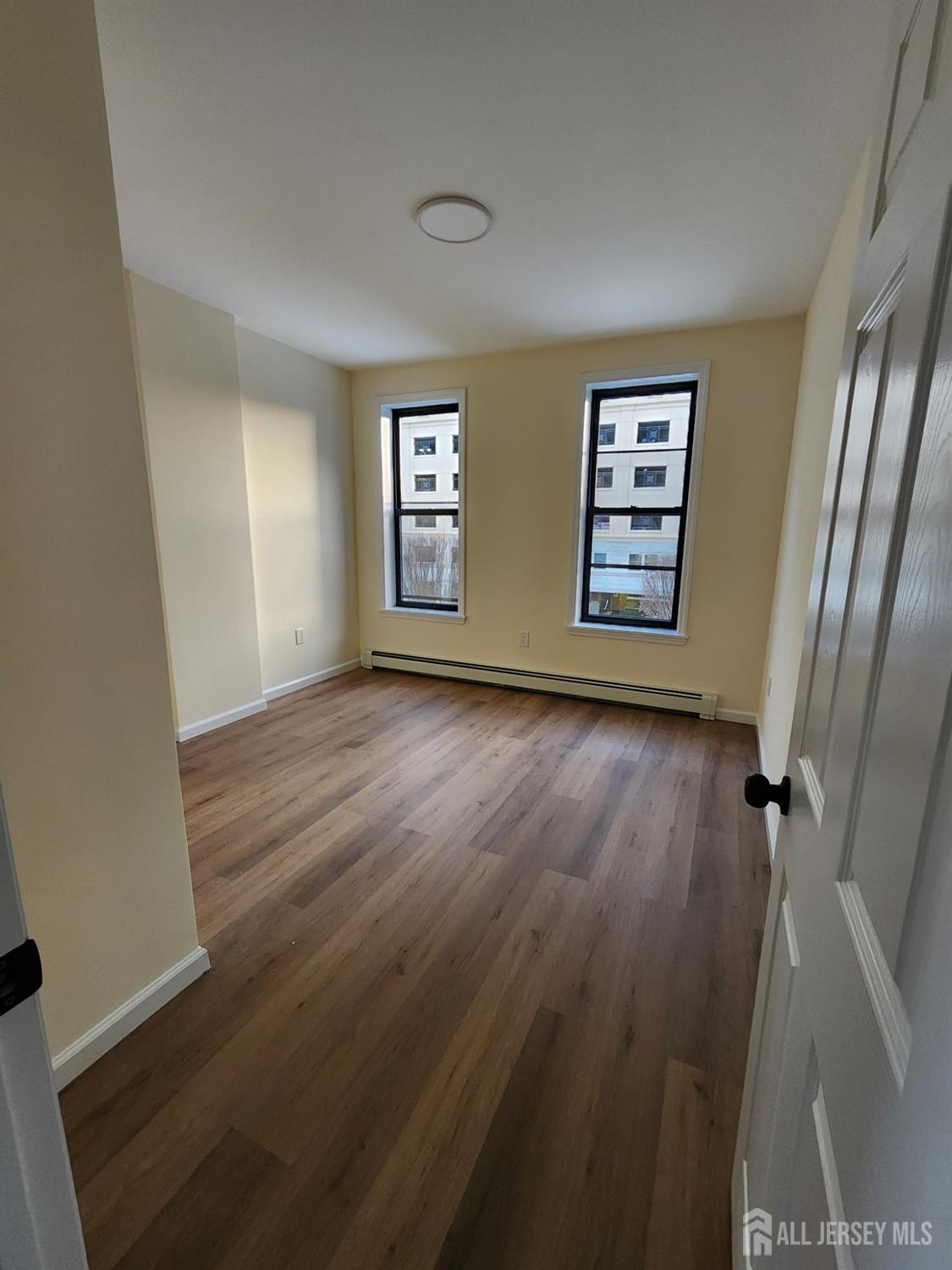 290 King Street, Unit 3 Perth Amboy, NJ 08861 - Photo 8 of 8 a view of livingroom with hardwood floor and window