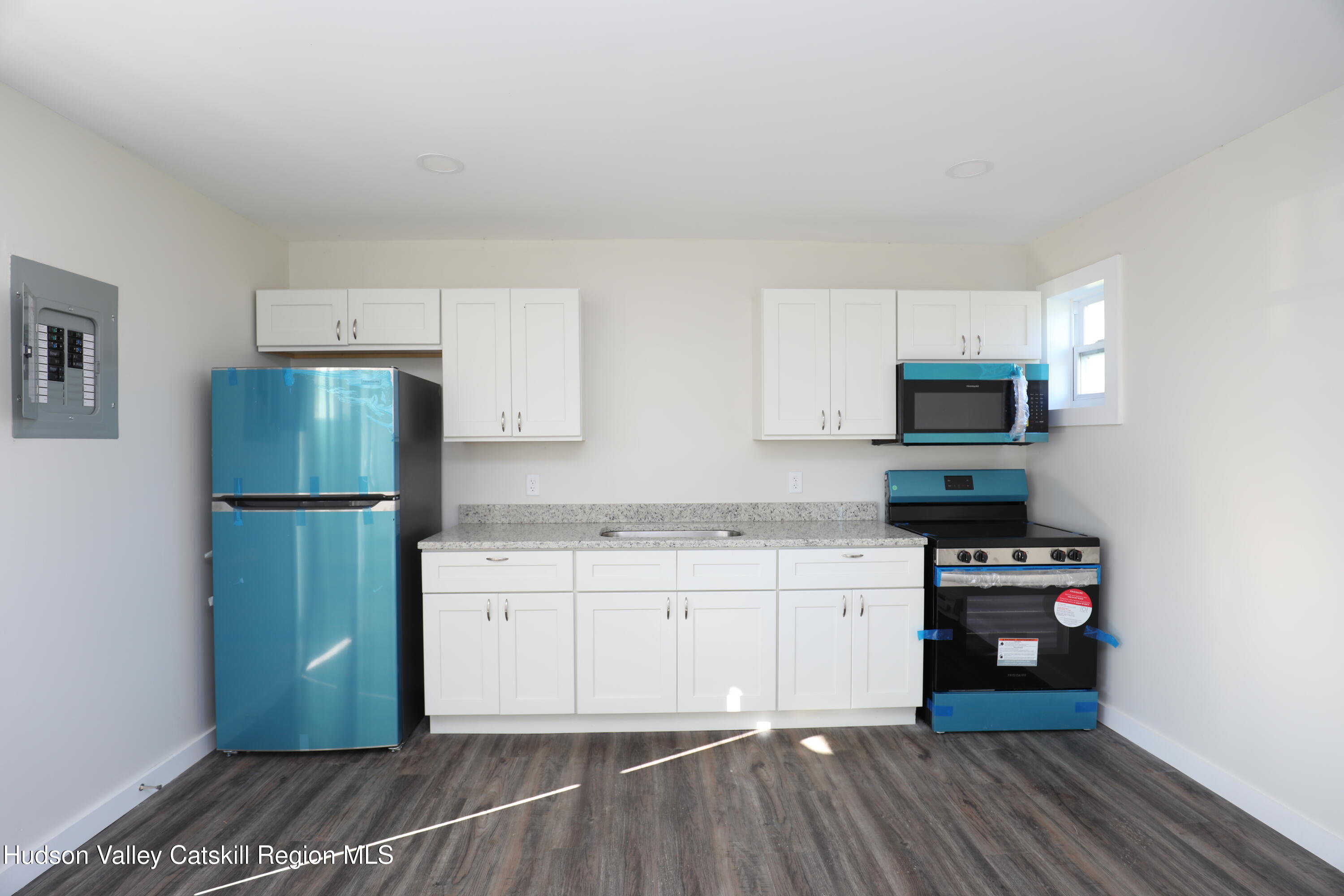 14311 Rte 9W, Unit 2 Ravena, NY 12143 - Photo 13 of 13 a kitchen with stainless steel appliances granite countertop a refrigerator and a stove top oven