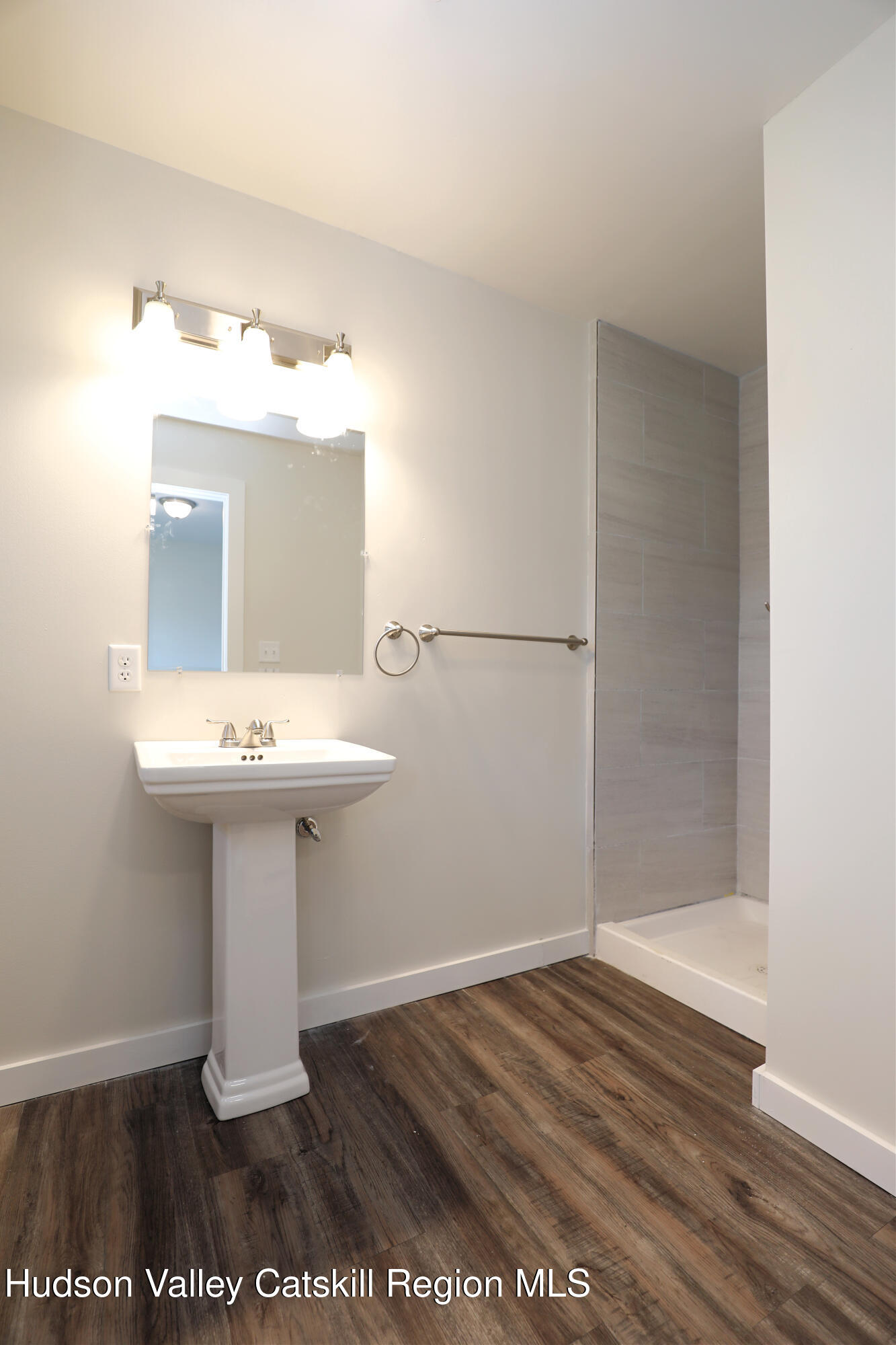 14311 Rte 9W, Unit 2 Ravena, NY 12143 - Photo 5 of 13 a bathroom with a sink and a mirror