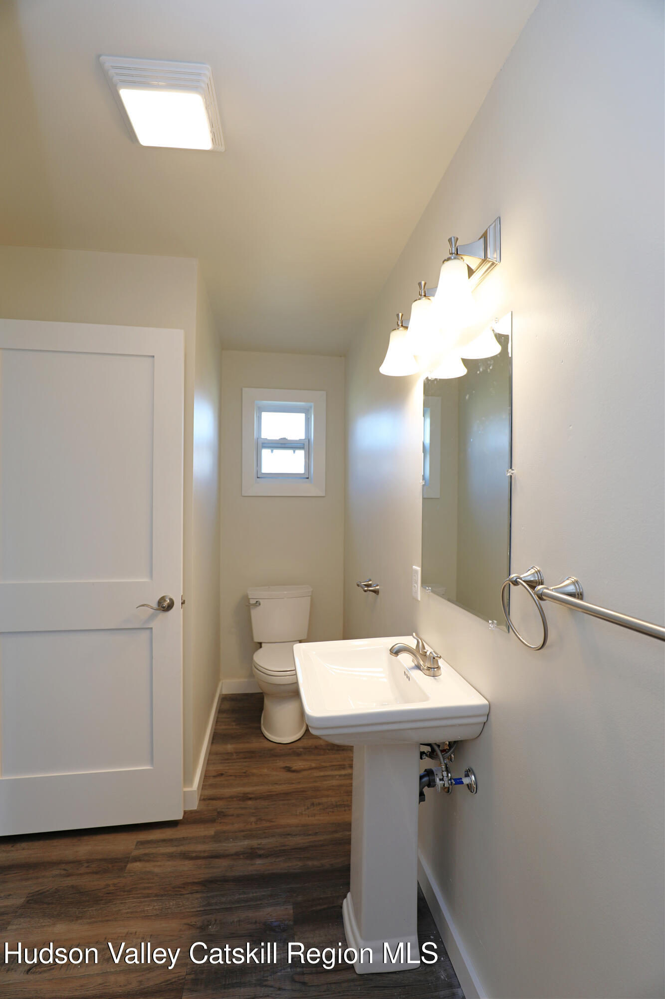 14311 Rte 9W, Unit 2 Ravena, NY 12143 - Photo 8 of 13 a bathroom with a sink a light fixture and a mirror