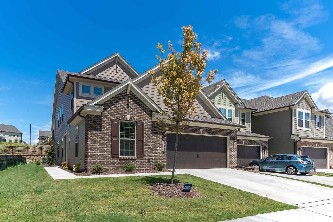 1524 Catch Fly Lane Durham, NC 27713 - Photo 2 of 25 a front view of a house with a yard and garage