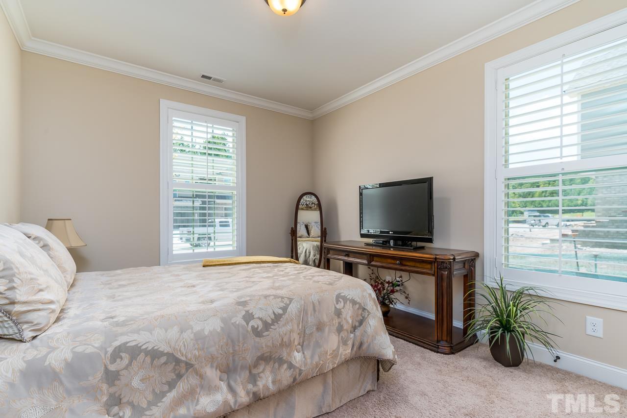 1524 Catch Fly Lane Durham, NC 27713 - Photo 11 of 25 a bedroom with a bed and a flat screen tv