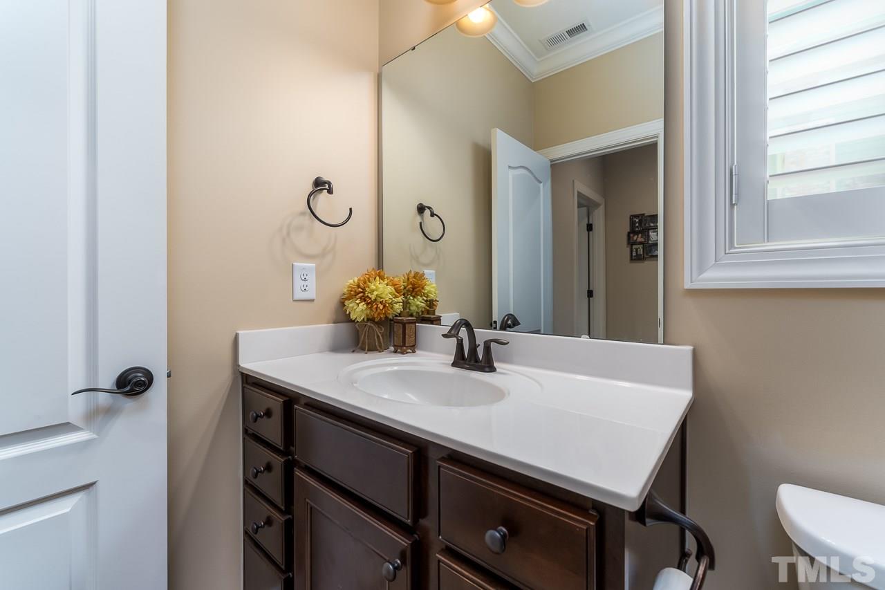 1524 Catch Fly Lane Durham, NC 27713 - Photo 12 of 25 a bathroom with a sink a mirror and a toilet