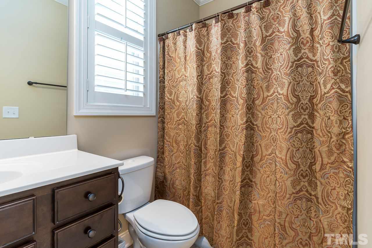1524 Catch Fly Lane Durham, NC 27713 - Photo 13 of 25 a bathroom with a toilet a sink and a window