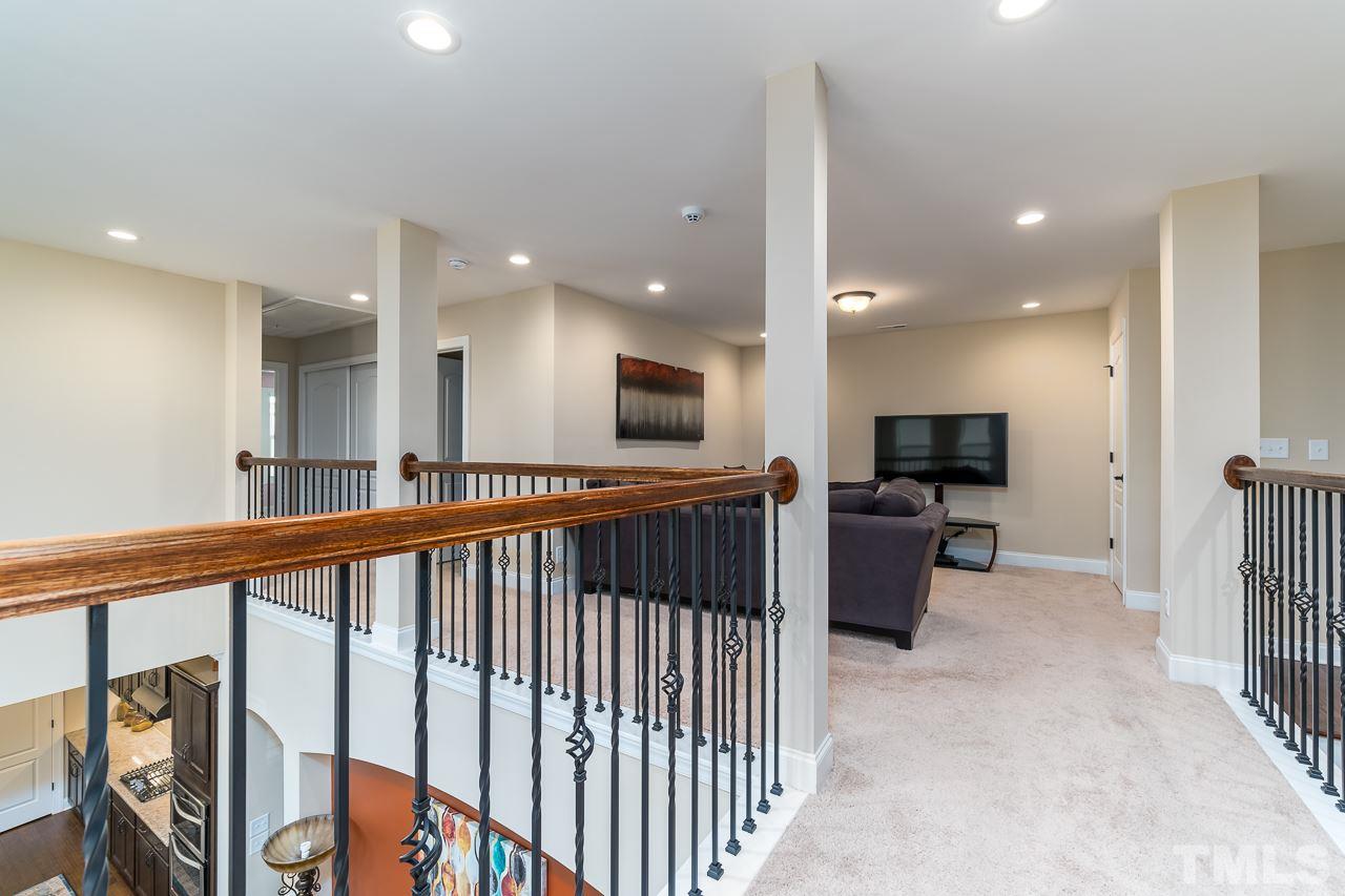 1524 Catch Fly Lane Durham, NC 27713 - Photo 15 of 25 a view of a living room a flat screen tv and a refrigerator