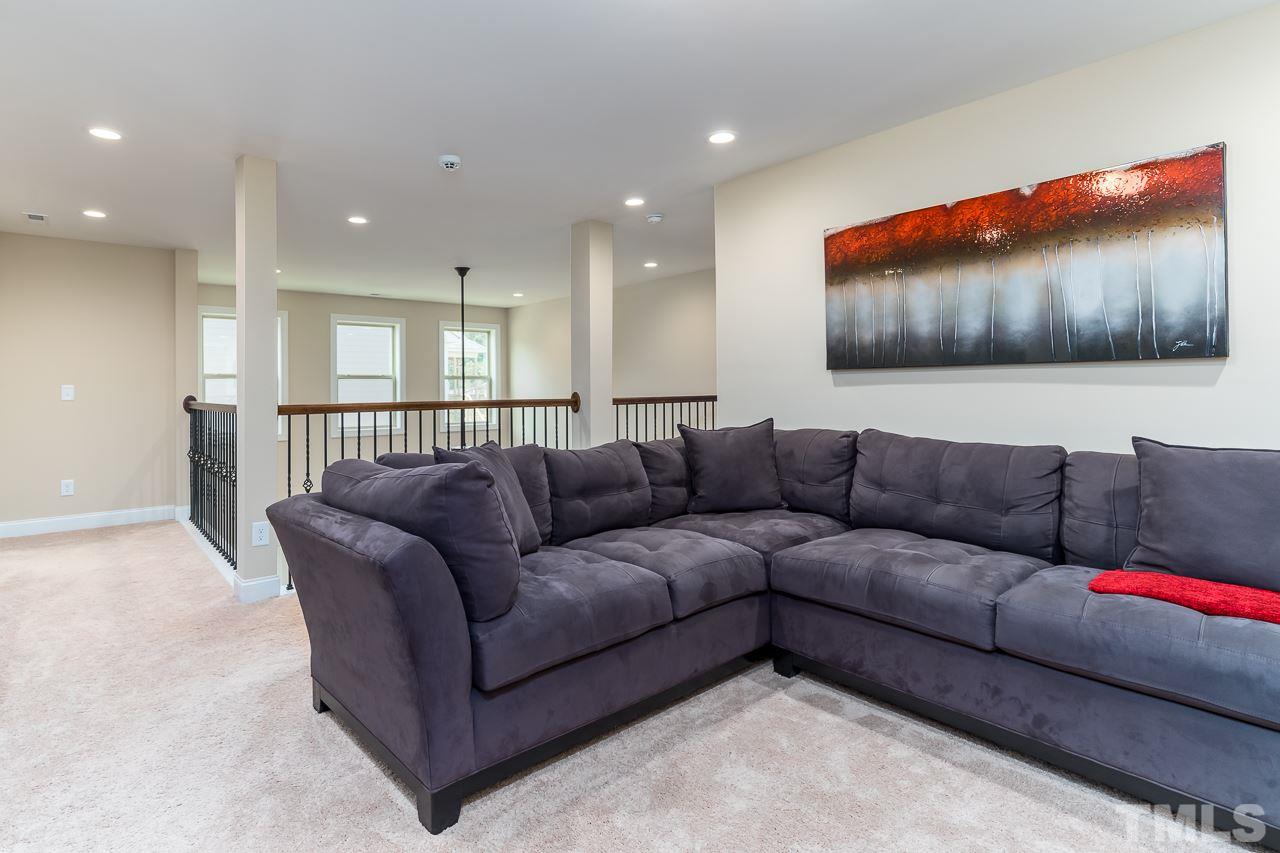 1524 Catch Fly Lane Durham, NC 27713 - Photo 17 of 25 a living room with furniture and a projector screen