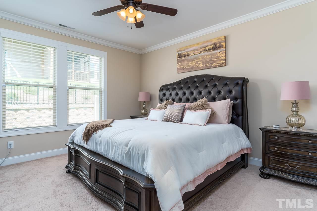 1524 Catch Fly Lane Durham, NC 27713 - Photo 18 of 25 a bedroom with a bed and a chandelier