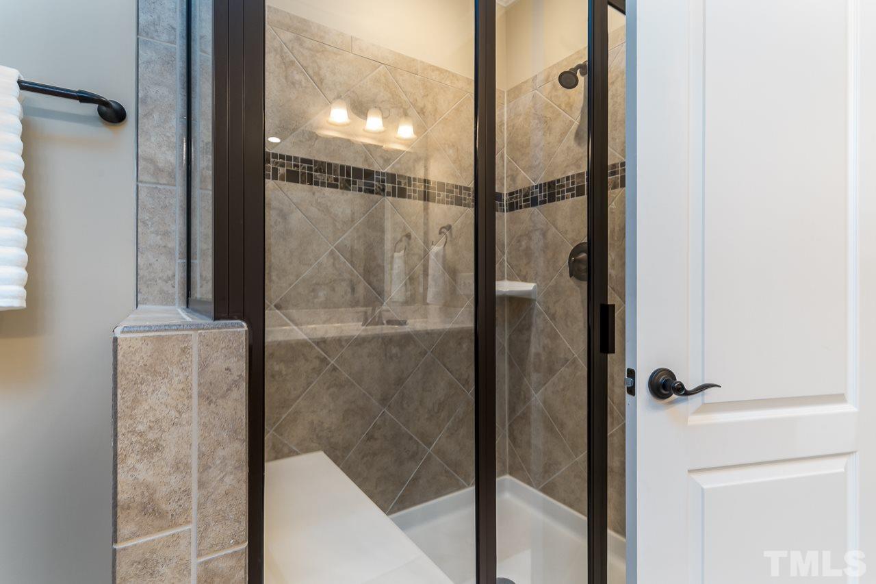 1524 Catch Fly Lane Durham, NC 27713 - Photo 21 of 25 a bathroom with a glass shower door