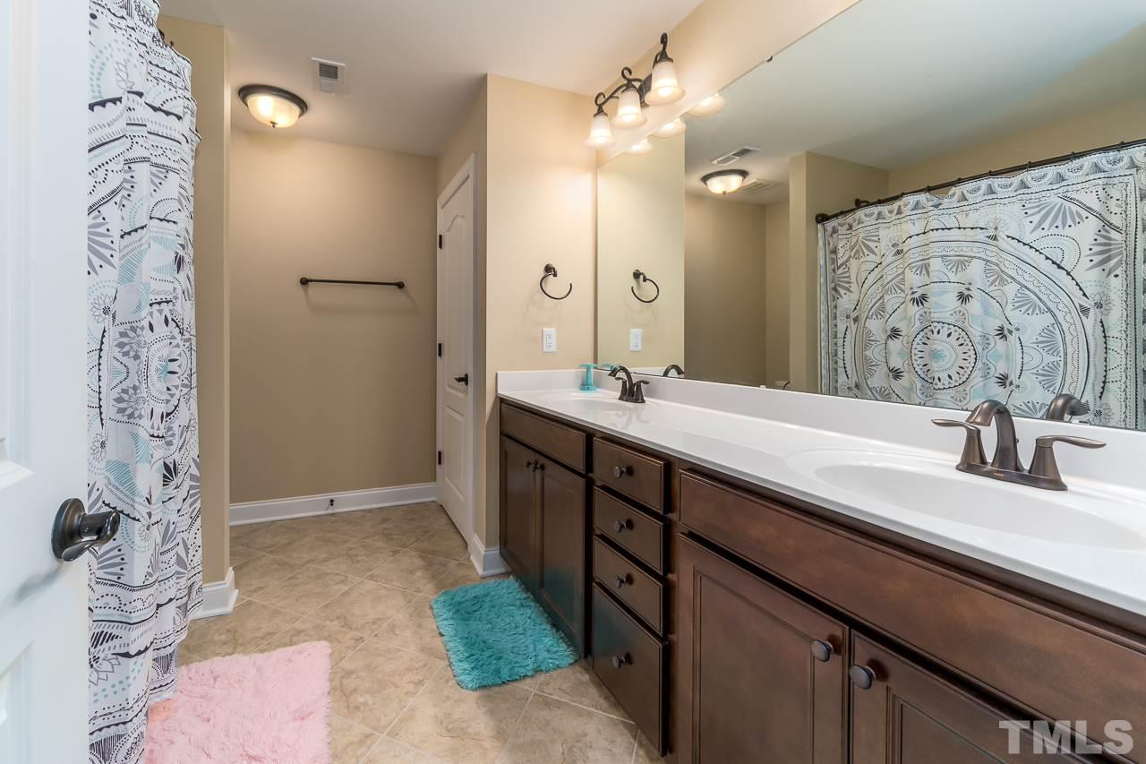 1524 Catch Fly Lane Durham, NC 27713 - Photo 24 of 25 a bathroom with a double vanity sink mirror and shower
