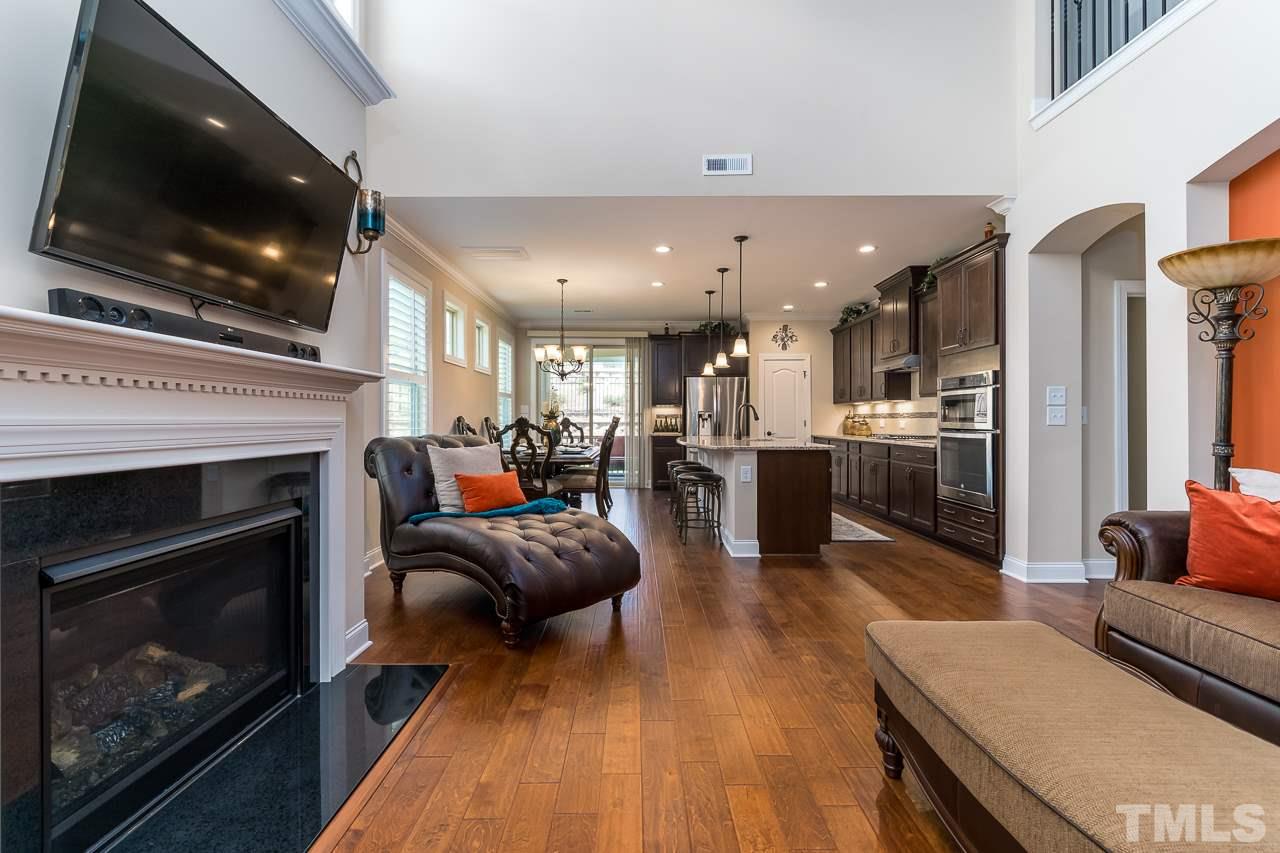 1524 Catch Fly Lane Durham, NC 27713 - Photo 4 of 25 a living room with furniture a flat screen tv and a fireplace