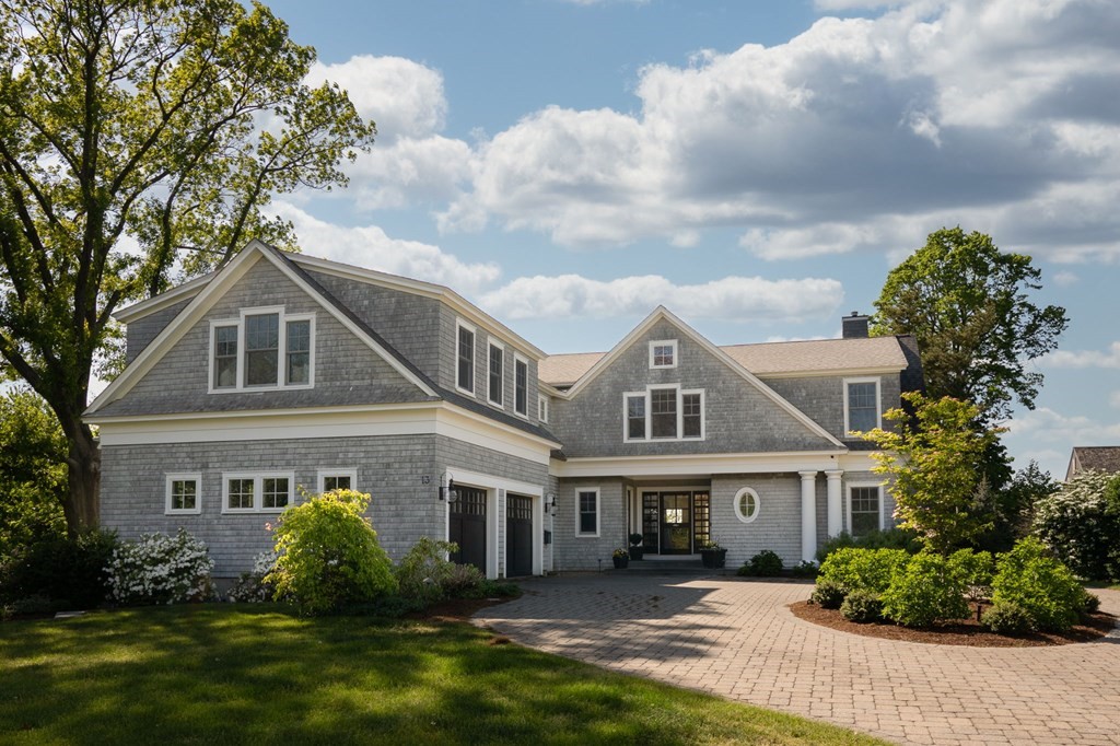 a front view of a house with a garden and plants
