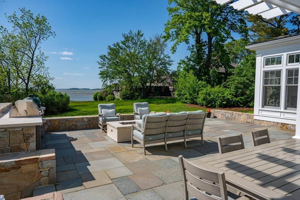 13 Martins Cove Road Hingham, MA 02043 - Photo 19 of 35 a view of a patio with couches and a fire pit
