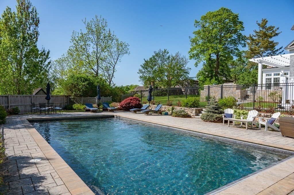 13 Martins Cove Road Hingham, MA 02043 - Photo 24 of 35 a view of a swimming pool with a table and chairs in patio