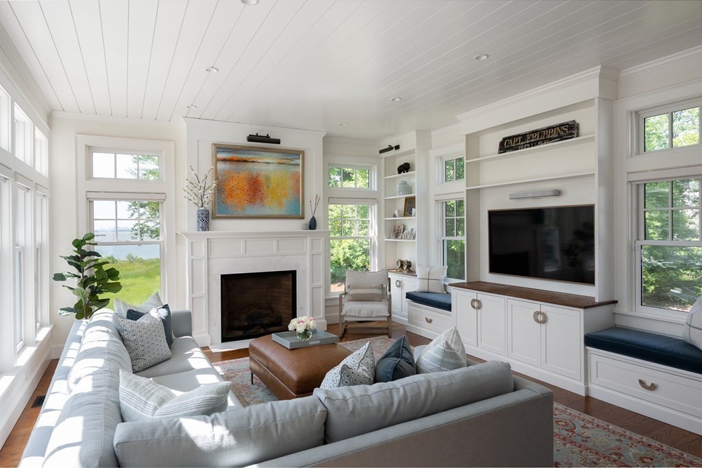 13 Martins Cove Road Hingham, MA 02043 - Photo 10 of 35 a living room with furniture a flat screen tv and a fireplace