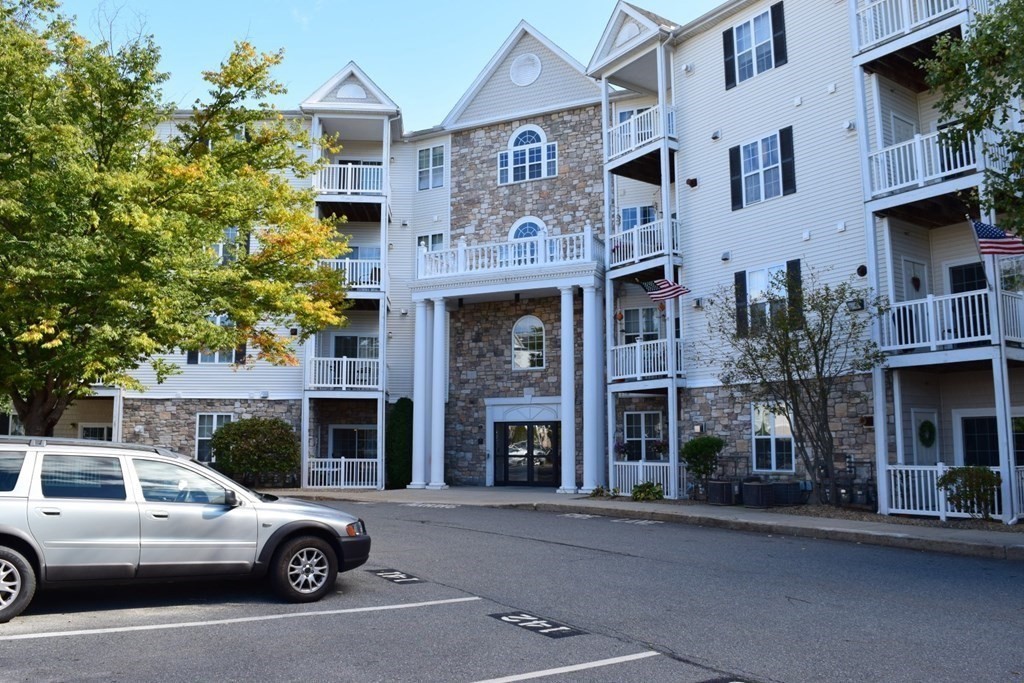 21 Hampshire Road, Unit 307 Methuen, MA 01844 - Photo 1 of 25 a front view of a residential apartment building with a yard