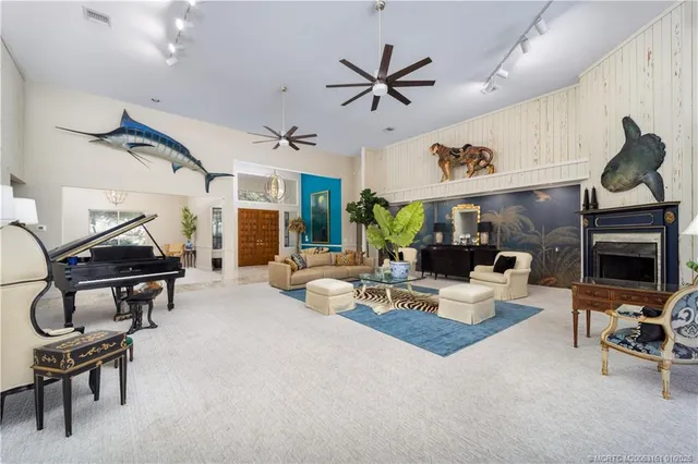 a living room with furniture a chandelier and a window