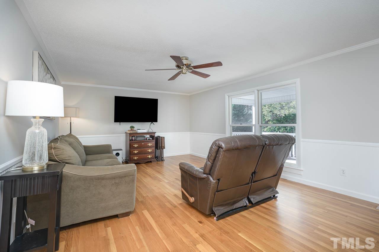 119 Community House Road Henderson, NC 27537 - Photo 2 of 10 a living room with furniture and a flat screen tv