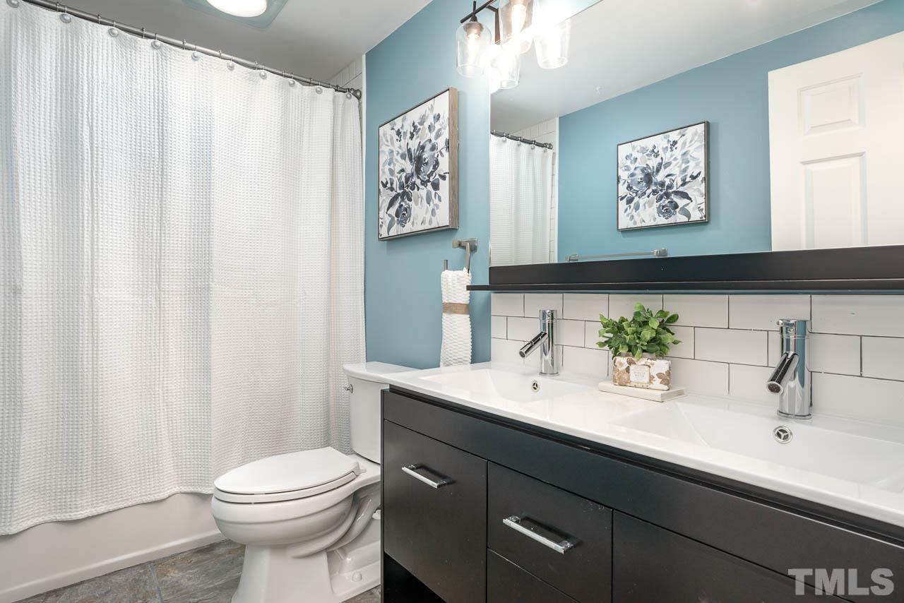119 Community House Road Henderson, NC 27537 - Photo 5 of 10 a bathroom with a sink a toilet and a mirror