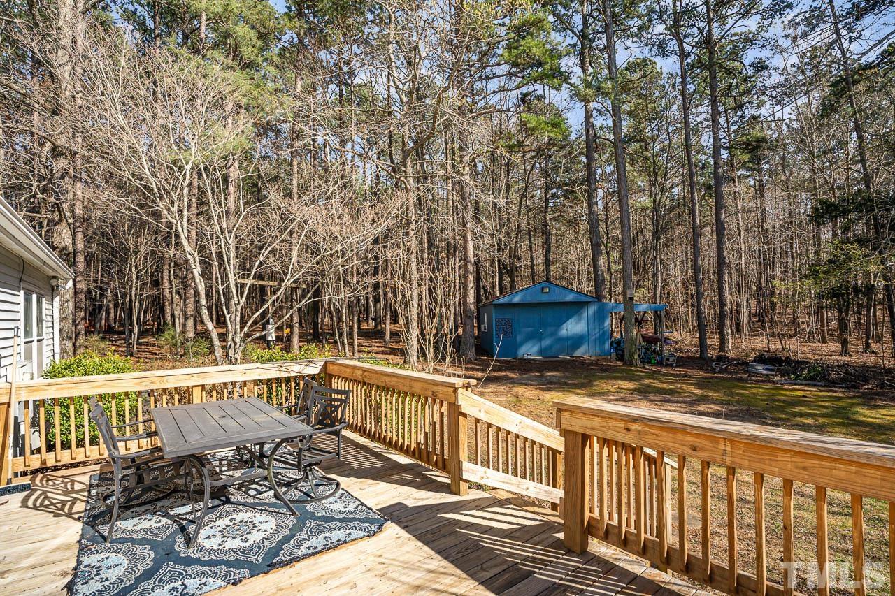 119 Community House Road Henderson, NC 27537 - Photo 8 of 10 a view of a wooden bench next to a yard