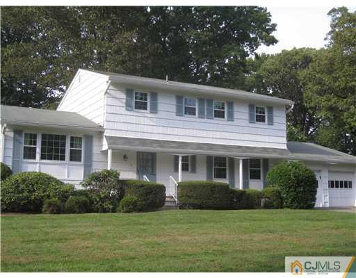 8 Woodruff Road Edison, NJ 08820 - Photo 1 of 21 a front view of a house with a garden